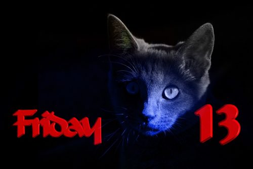Superstitious black cat and friday the 13th signs in one image with a black background